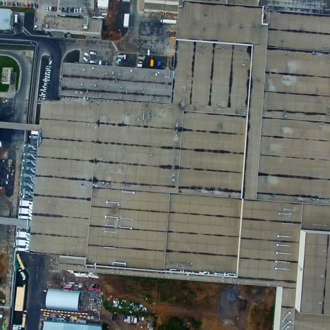industrial plant outdoors. large factory on field. roofs of buildings of modern industrial plant. top down. aerial view.