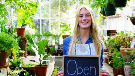 portrait of beautiful woman holding open sign