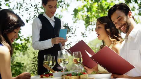 waitress taking an order from couples