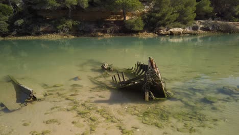 sunken skeleton boat abandoned in still waters, static shot