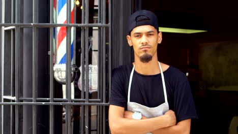 male hairdresser standing with arms crossed at the entrance 4k