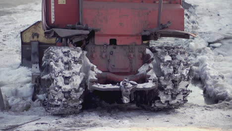 red tractor with snow tracks in winter