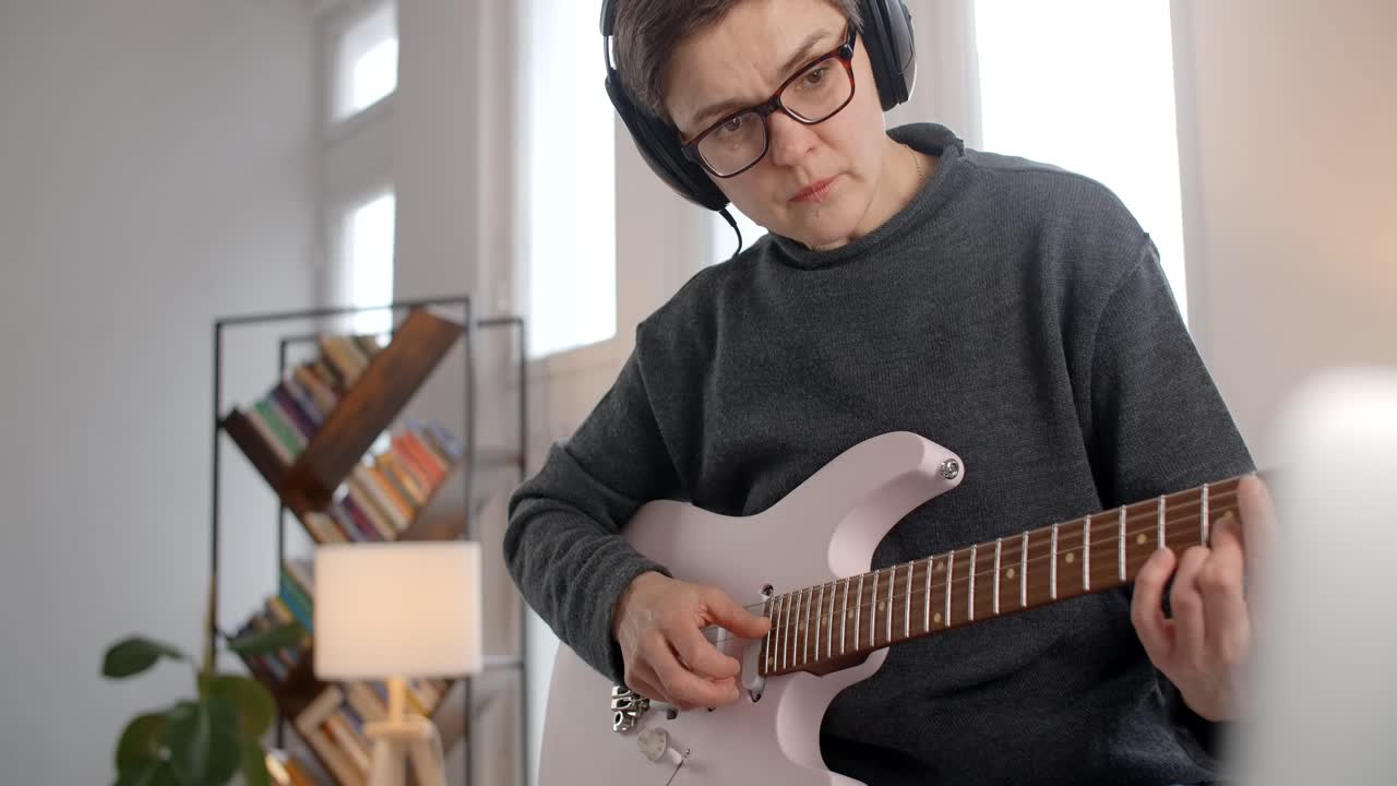 Woman Learning Electric Guitar at Home