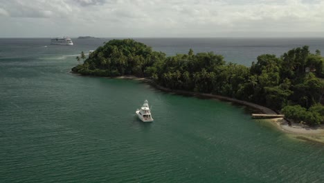 aerial view of beautiful exotic island with visiting tourist on luxury speedboat and cruise liner in background - samana bay,dominican republic in summer