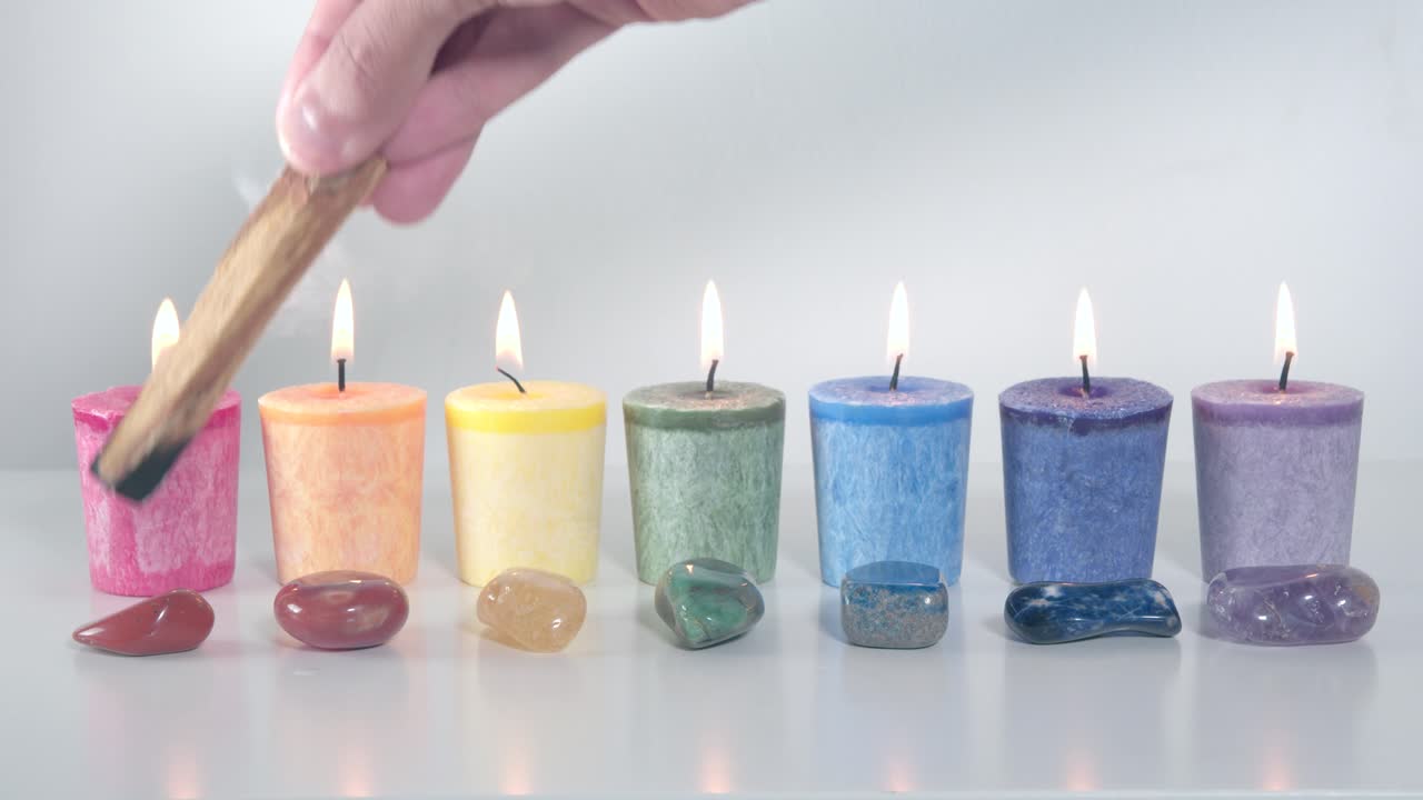 Smudging the seven chakra system candles and gemstones