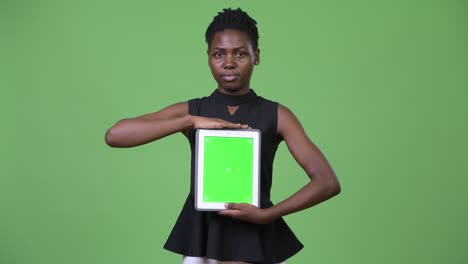 young beautiful african businesswoman showing digital tablet