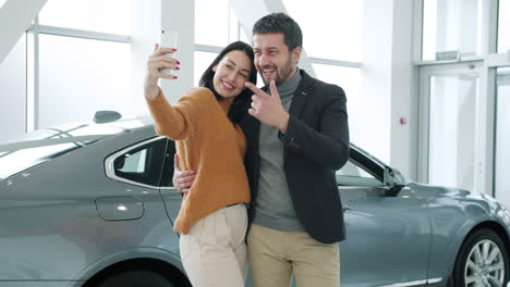 Couple taking a selfie in a car showroom