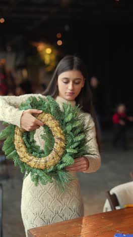 woman making a christmas wreath