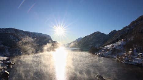 a boat glides through misty morning frost on norwegian fjord