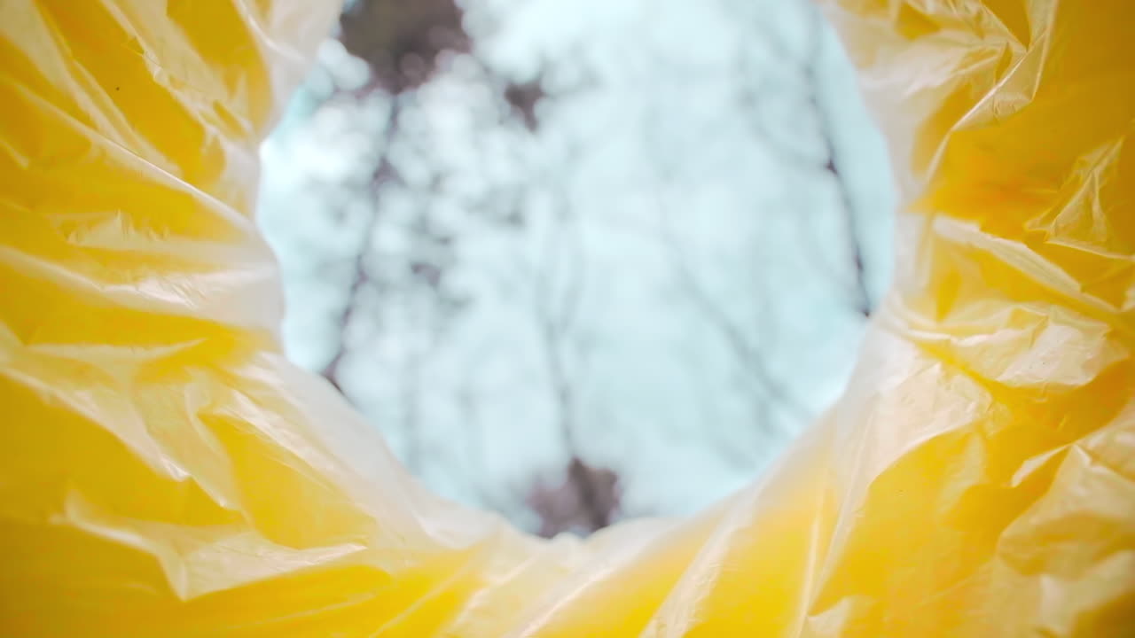 Man throwing a medical mask into a trash can. View from inside the can. Slow motion
