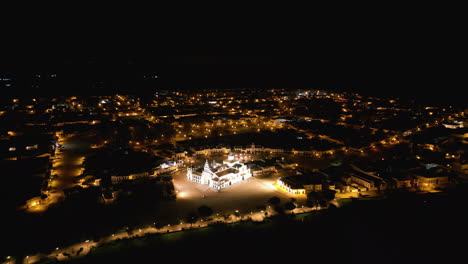 the famous bright white church in el rocio. nightime drone shot captures the beauty at night