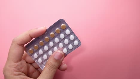 woman holding a pack of birth control pills