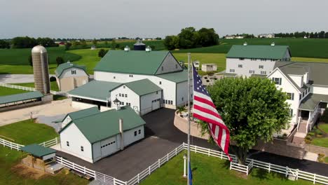 Aerial-orbit-of-farm-and-home-in-green-rolling-hills-of-United-States