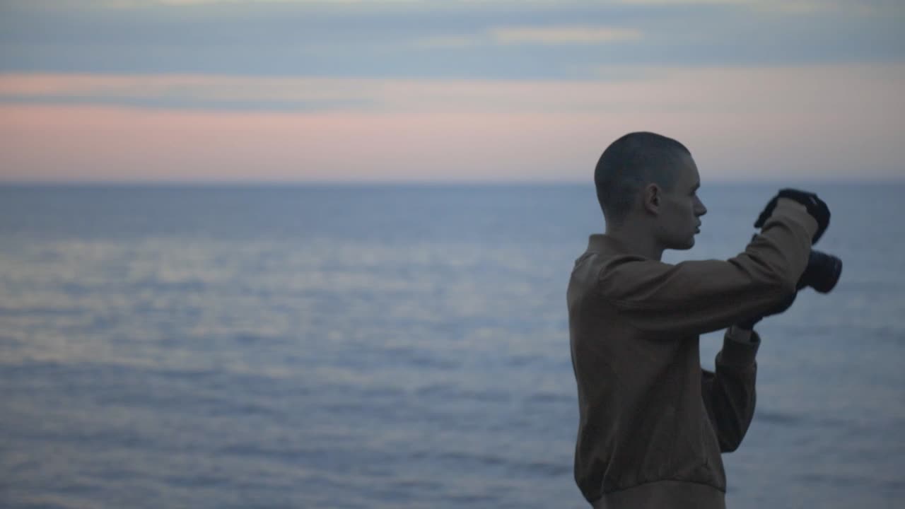 Man Taking Professional Photos At A Beautiful Beach - medium shot