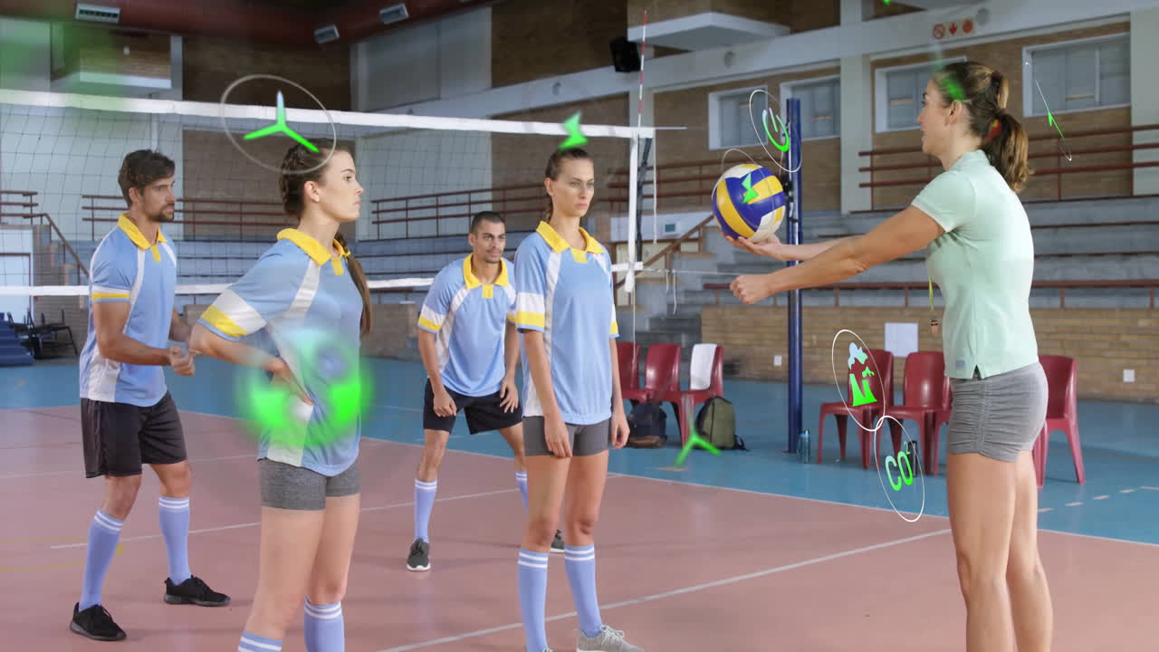 In school gym, volleyball coach instructing team using animation for techniques
