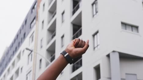 African-american-woman-raising-her-fist-in-street