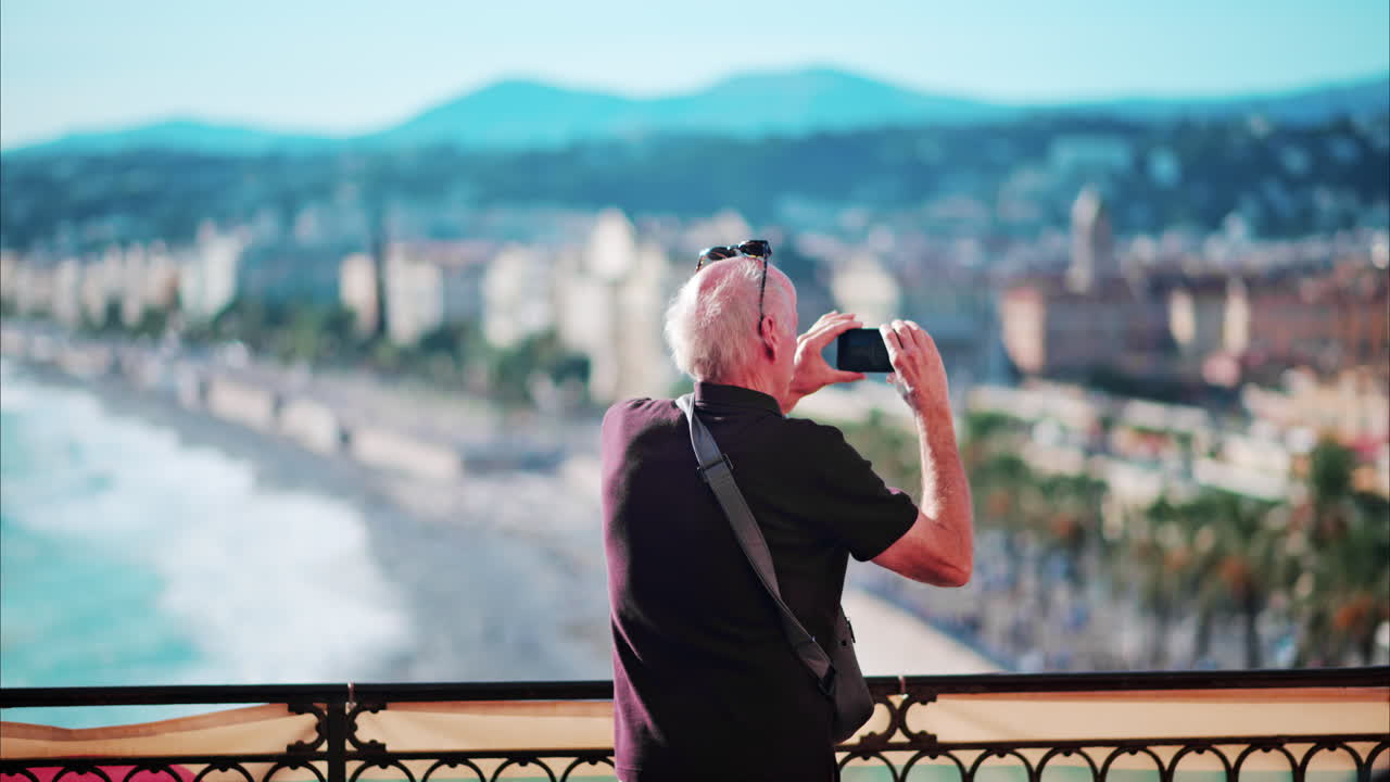 Man taking pictures at a viewing point in Nice, France
