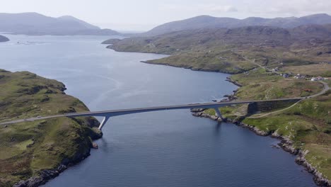 retreating drone shot of the bridge connecting the isle of scalpay to the isle of harris on the outer hebrides of scotland