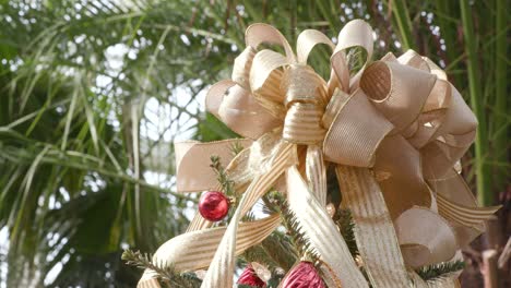 decorated christmas tree with festive golden bow