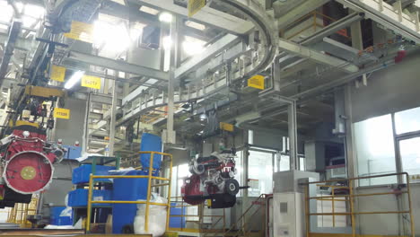 industrial workshop modern diesel engine production of powerful heavy duty truck engine being assembled on a production line in spacious car manufacturing plant well-lit automotive factory