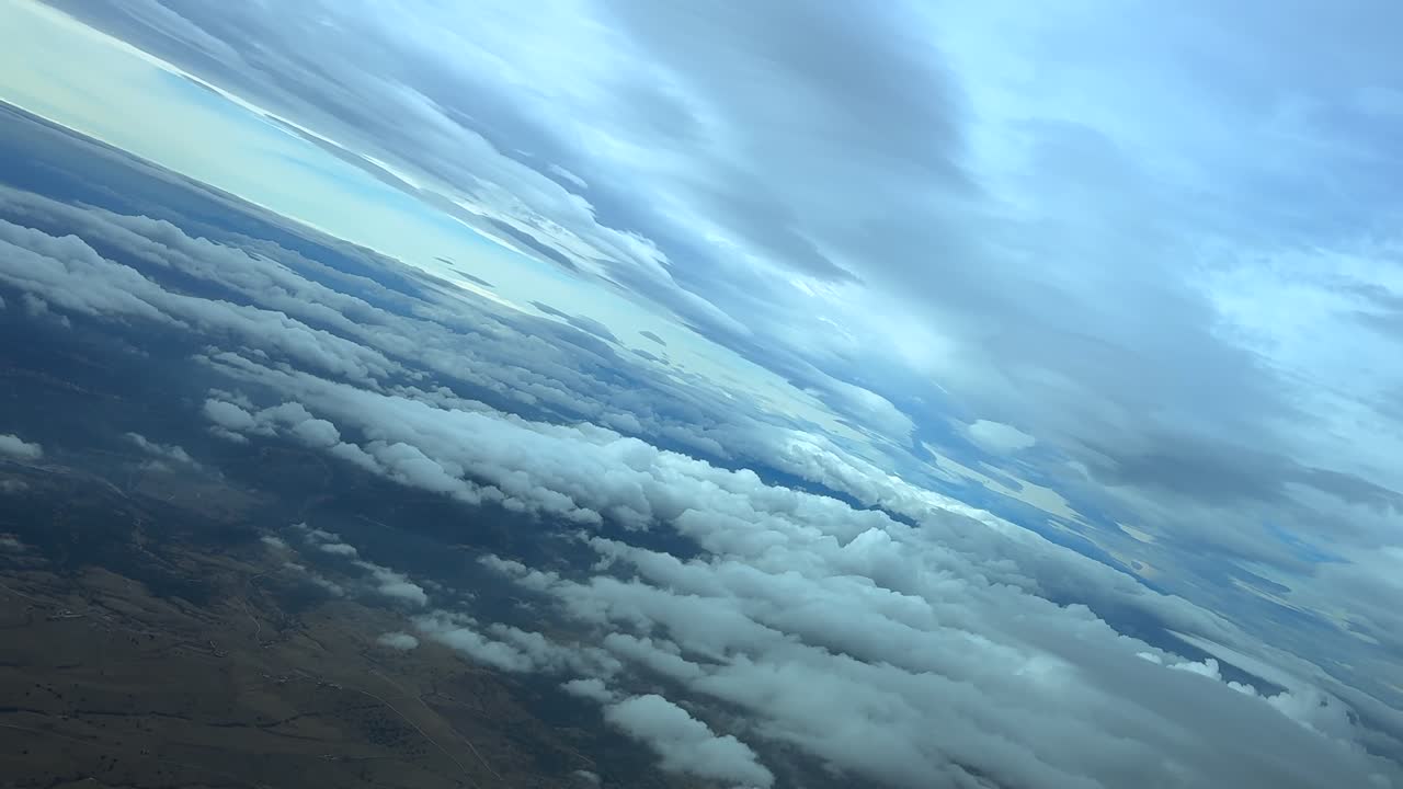 Immersive cockpit view in a left turn flying through multilayered clouds in a quiet winter sky