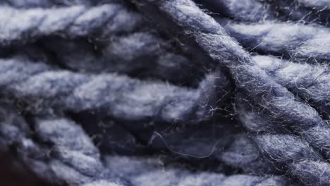 Micro-video-of-close-up-of-purple-woolly-threads-with-copy-space