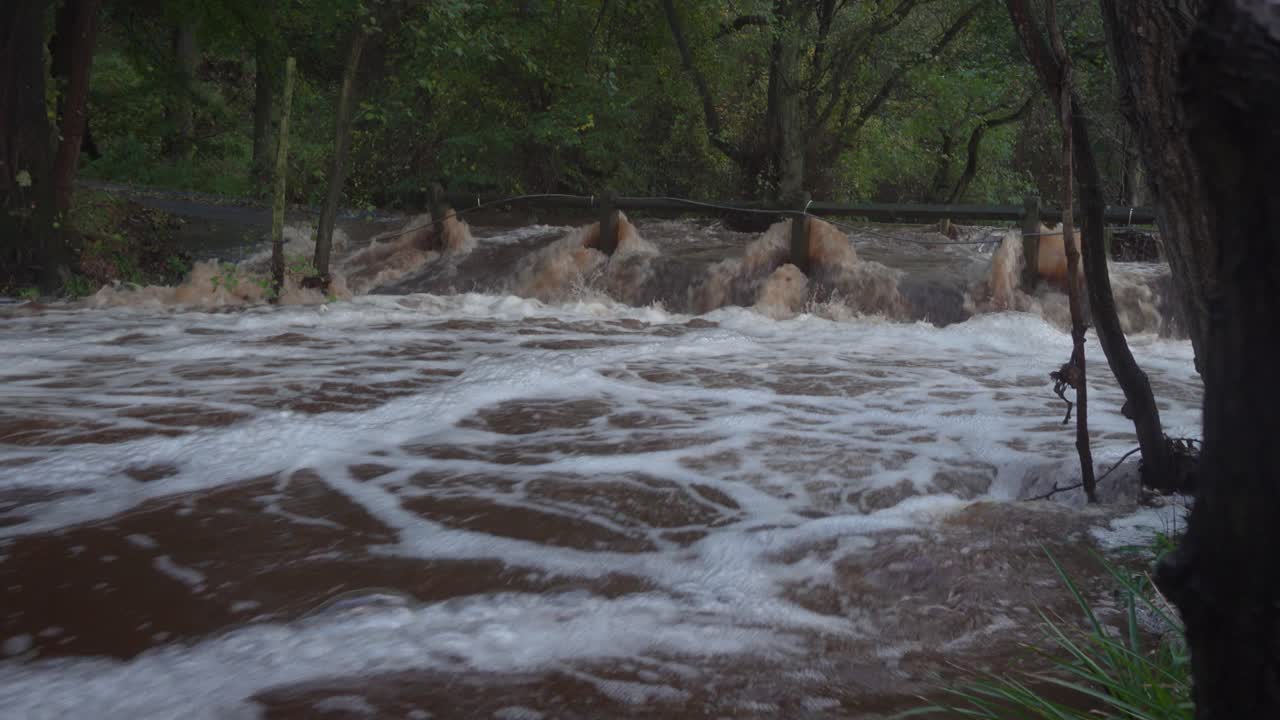 Fast flowing flood water over the ford on the River Esk at Westerdale, after a very wet day on the North York Moors October 31st  2021
