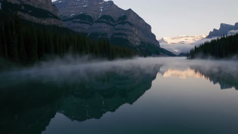 misty sunrise over mountain lake