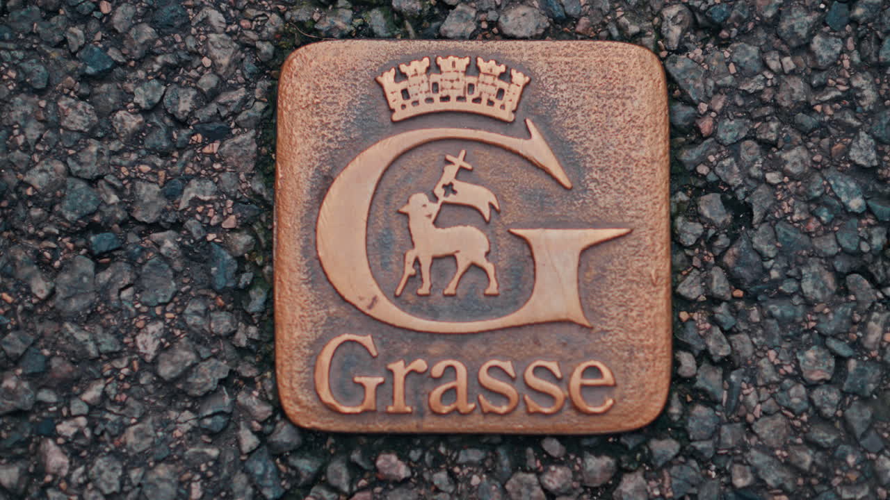 Grasse emblem engraved in the ground in France