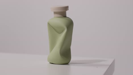 close up of empty squeezed bottle of beauty product shot on white background 1