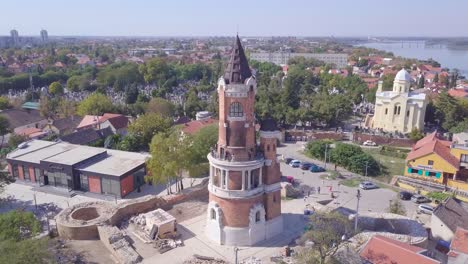 Slow-beautiful-orbiting-aerial-shot-of-Gardos-Tower-in-Zemun-Old-city,-summer-day-4k