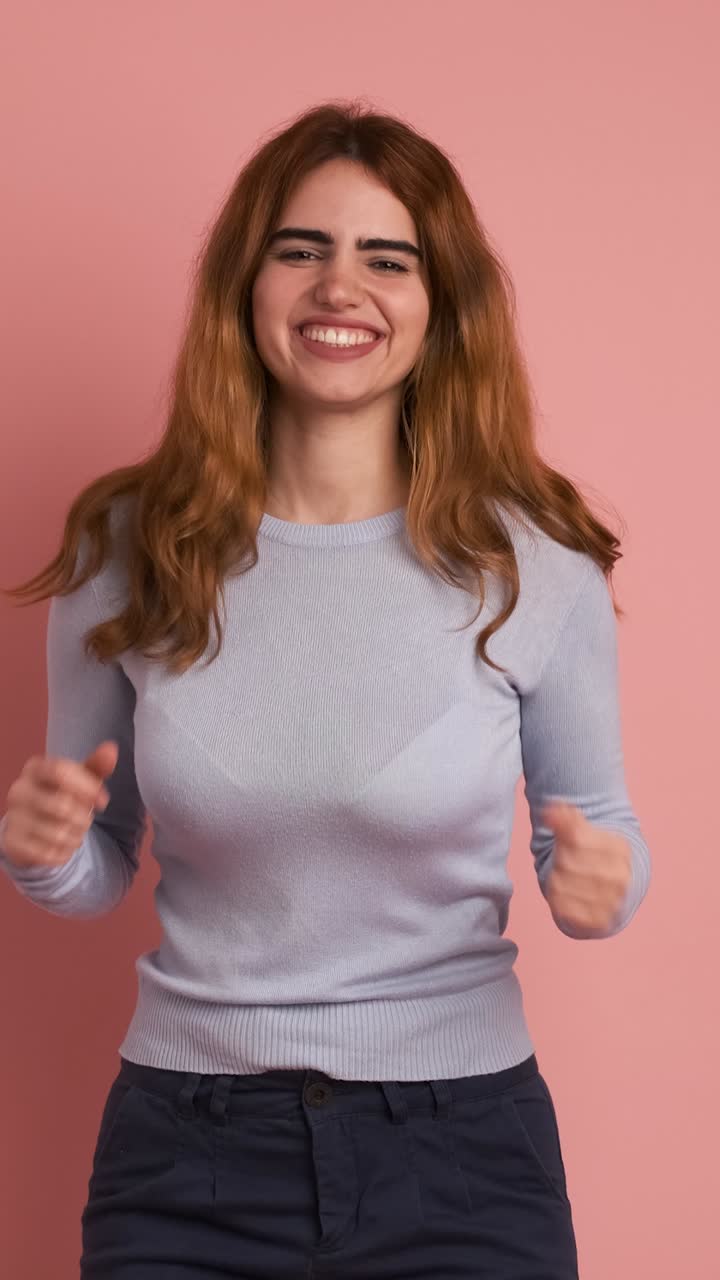 Surprised woman smiling at camera and celebrating. Vertical Footage