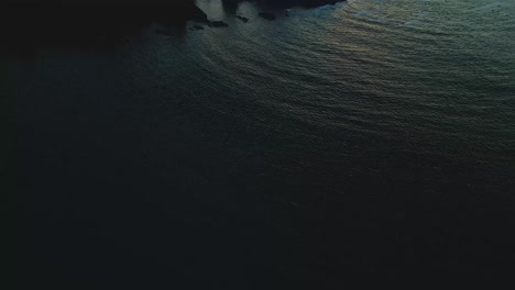 Aerial-sunset-at-Yaquina-Head-Lighthouse-beach-in-Newport,-Oregon