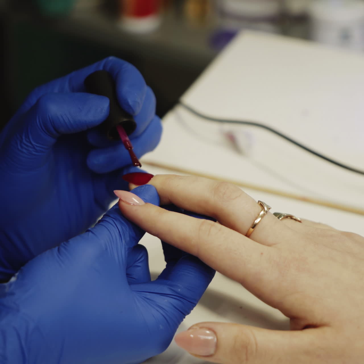 Master of nails makes a professional manicure. Beautiful female hands. Hand care in the spa. Close-up Square video