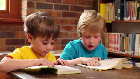 cute pupils reading in library