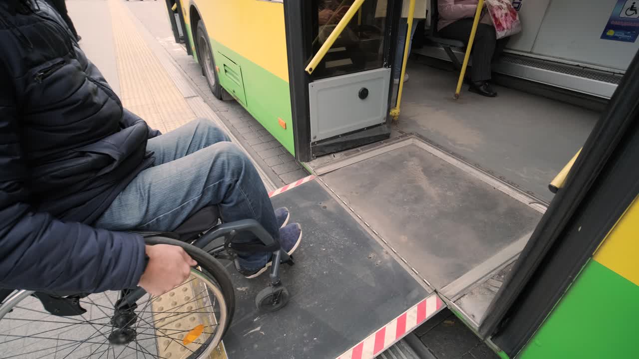 Person with a physical disability enters public transport with an accessible ramp