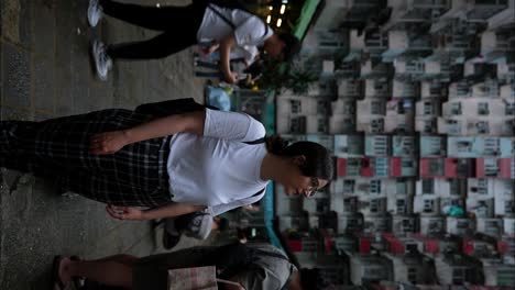 caucasian woman surrounded by chinese locals in yick cheong building, hong kong