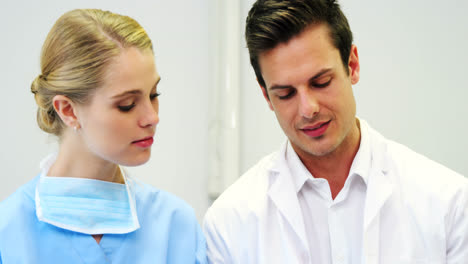 happy dentist and nurse using digital tablet