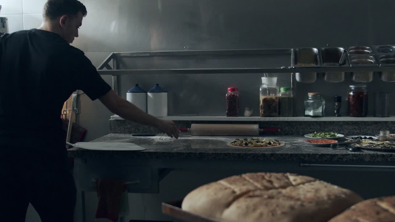 Raw pizza on shovel before baking