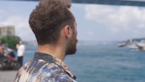 thoughtful man watching the bridge over the strait.