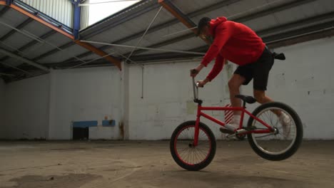 BMX-rider-in-an-empty-warehouse