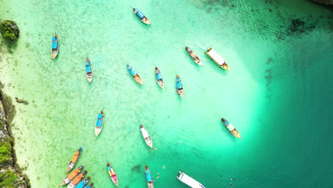 Many-tourist-boat-gathering-in-Pi-Leh-bay,-aerial-top-down-view