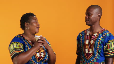 Ethnic-couple-enjoying-aroma-of-fresh-coffee-drink