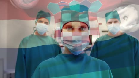 Animation-of-waving-croatia-flag-over-portrait-of-diverse-surgeons-in-surgical-masks-at-hospital