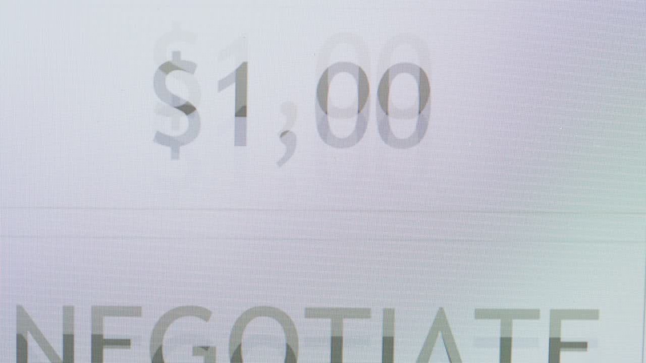 Close-up of Scrolling Dollar Amounts on a Digital Screen