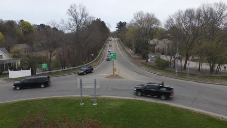 low, static drone view of traffic on a two-lane roadway in new england