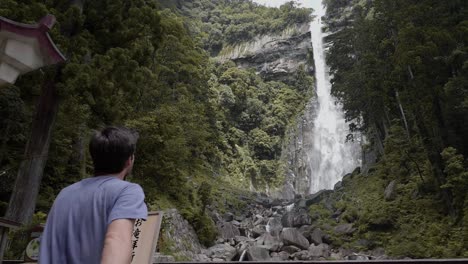 Man-walking-up-to-Nachi-Falls-in-Nachikatsuura,-Japan