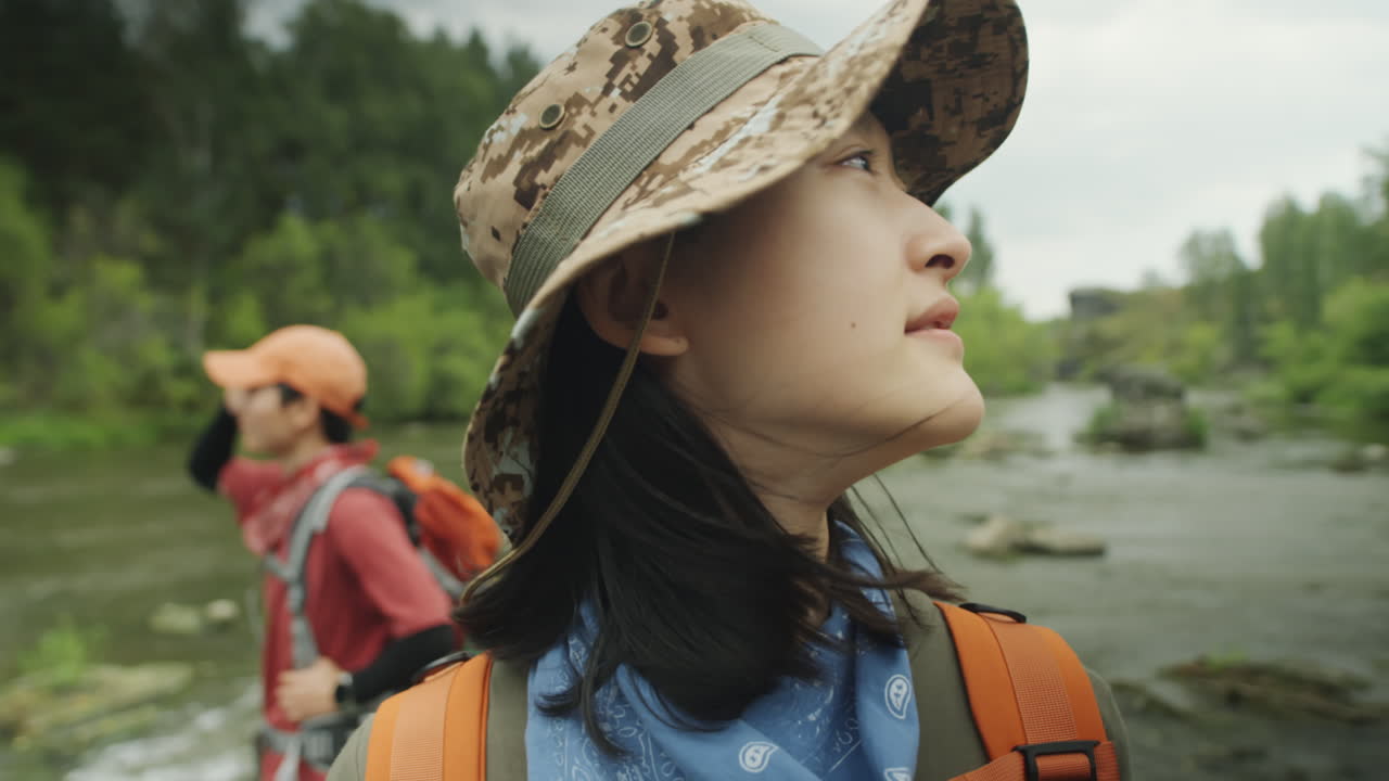 Female Tourists Standing in River and Enjoying View