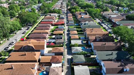 chicago suburb with rows of brown-roofed houses and green yards in summer