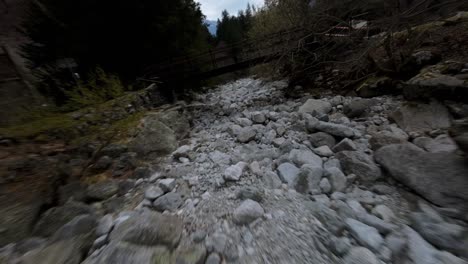 Aerial-FPV-Following-Another-Drone-Over-Rocks-And-Trees-In-Val-Masino,-Italy